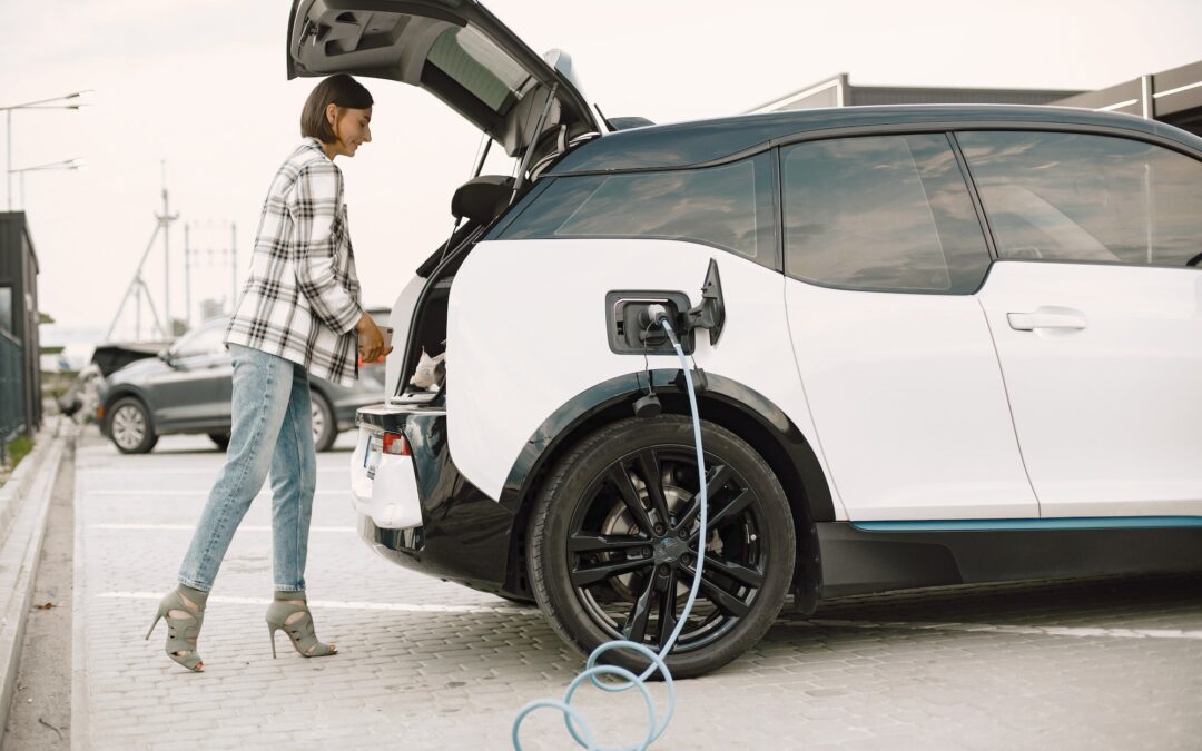 Businesswoman on the electric cars charge station